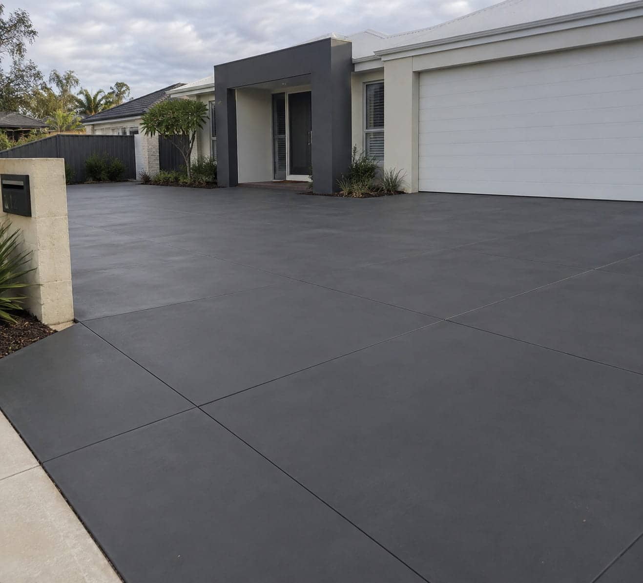 Coloured concrete driveway in a warm oxide tone