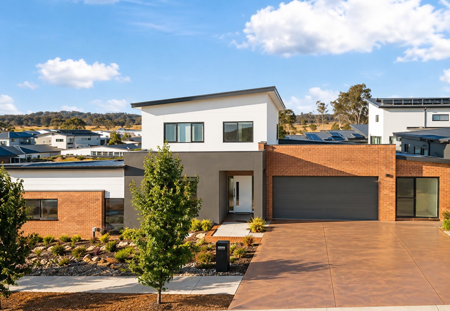 Terracotta coloured concrete driveway at a new home in Barton, ACT
