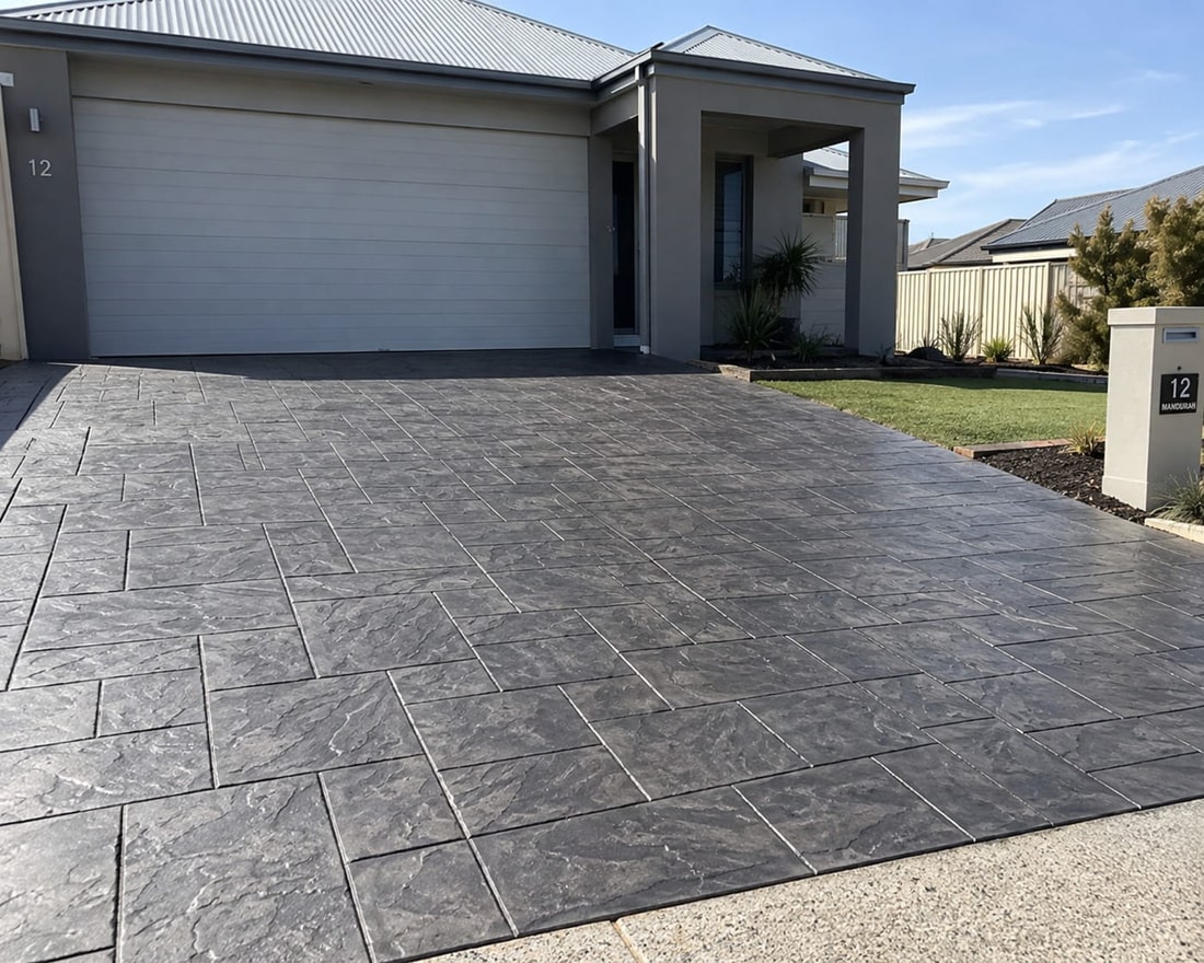 Charcoal slate-look stamped concrete driveway at a Canberra home, stamped in a running-bond tile pattern