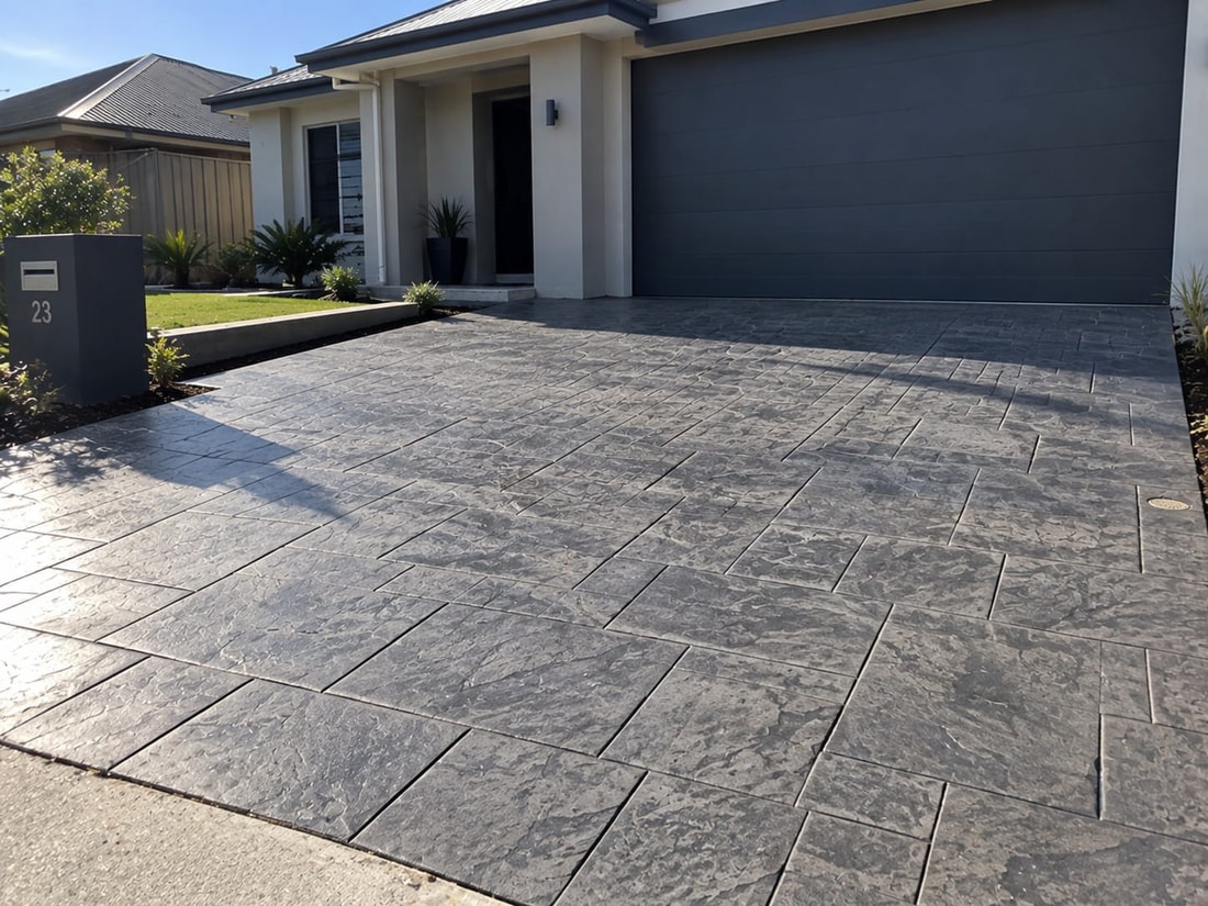 Charcoal slate-pattern stencilled concrete driveway at a Canberra home, laid in a regular tile pattern
